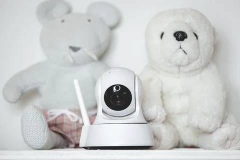IP camera on the shelf with toys, serving as baby monitor 스톡 사진