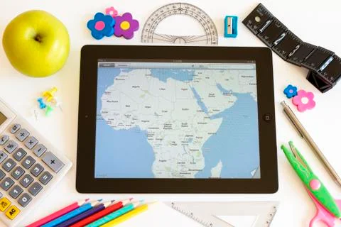 Ipad 3 with maps and school accesories 库存照片