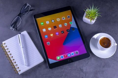 IPad 8th generation with notebook, cofe and glasses on desk Фото