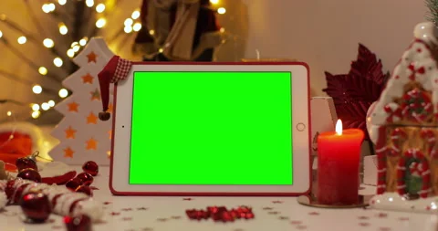  iPad Air tablet with pre-keyed green screen and Santa Claus hat on top standing Stock Footage 144378728