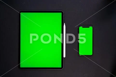 IPad and iPhone, on a black background, top view Stock Photos