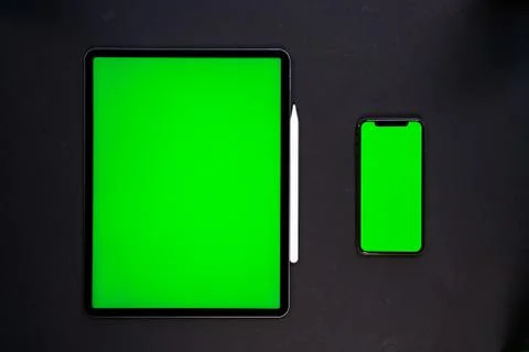 IPad and iPhone, on a black background, top view Stock Photos