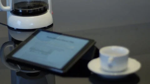 Ipad with coffee maker and empty white coffee cup on a saucer Stock Footage 74570418