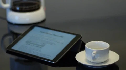 Ipad with coffee maker and empty white coffee cup on a saucer Stock Footage 74570453