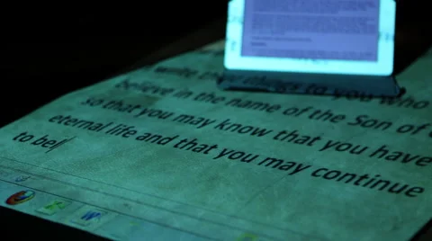 Ipad on desk with projected Bible passage 3 Stock Footage 47485492