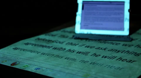 Ipad on desk with projected Bible passage 3 Stock Footage 47486267