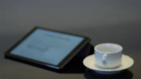 Ipad with empty white coffee cup on a saucer Stock Footage 74570445