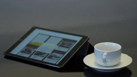 Ipad with empty white coffee cup on a saucer Stock Footage 74570456