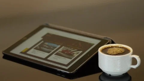Ipad with full white coffee cup Stock Footage 74570432