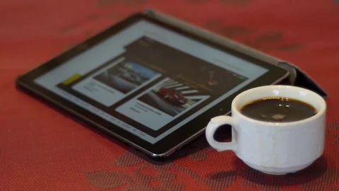 Ipad with full white cup of coffee Stock Footage 74570513