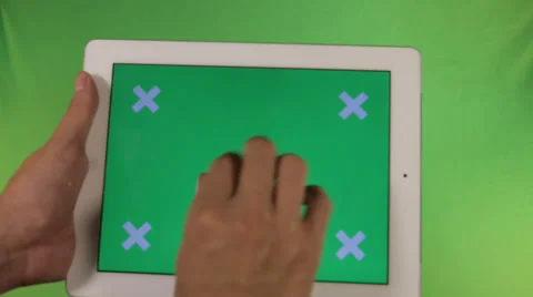 Ipad in the hands of a green screen with labels Stock Footage 41087320