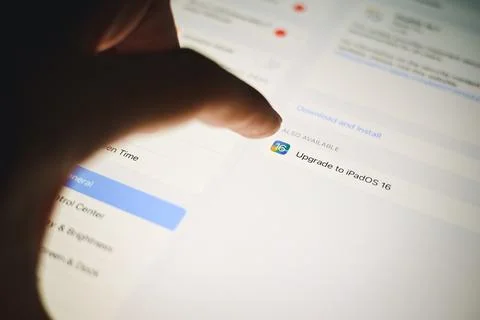 Ipad with Ipad OS 16 logo on the screen while updating to IOS16 screen close  Stock Photos