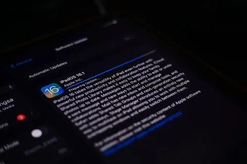 Ipad with Ipad OS 16 logo on the screen while updating to IOS16 screen close  Stock Photos