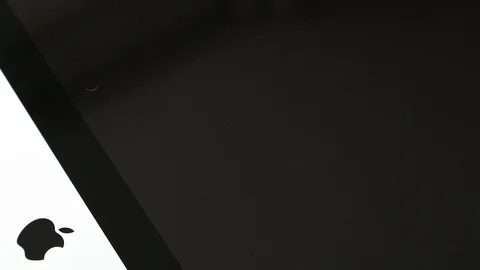 IPad tablet above Apple iMac computer Stock Footage 107783808