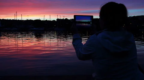 IPad, tablet computer: woman making photos of the sunset on the river 스톡 동영상 54178385
