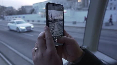 IPhone 11 in men's hands making photo video of road in tram vienna Stock Footage 123279920