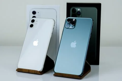 IPhone 11 Pro Max in midnight green color next to iPhone 11 in white. Stock Photos