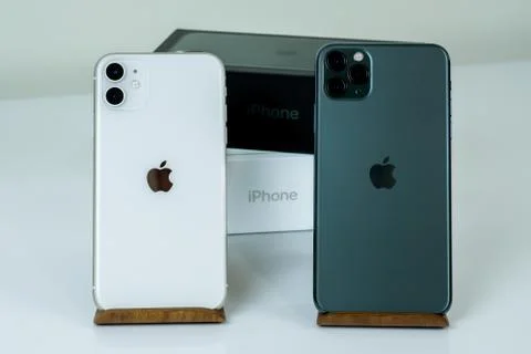 IPhone 11 Pro Max in midnight green color next to iPhone 11 in white. Stock Photos