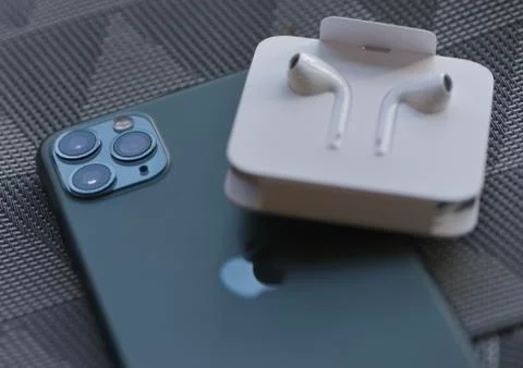 IPhone 11 Pro Max with original earphones and fast charger Stock Photos