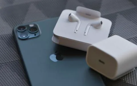 IPhone 11 Pro Max with original earphones and fast charger Stock Photos