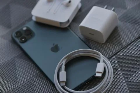 IPhone 11 Pro Max with original earphones and fast charger Stock Photos