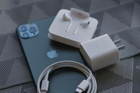 IPhone 11 Pro Max with original earphones and fast charger Stock Photos