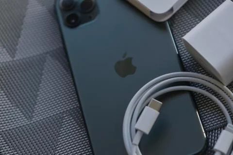IPhone 11 Pro Max with original earphones and fast charger Stock Photos