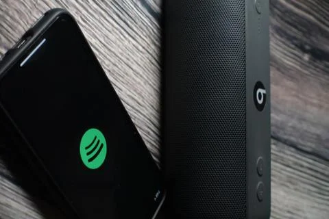 An iphone 11 screen showing spotify icon Stock Photos
