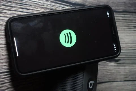 An iphone 11 screen showing spotify icon Stock Photos