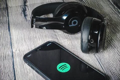 An iphone 11 screen showing spotify icon with beats earphone 写真素材