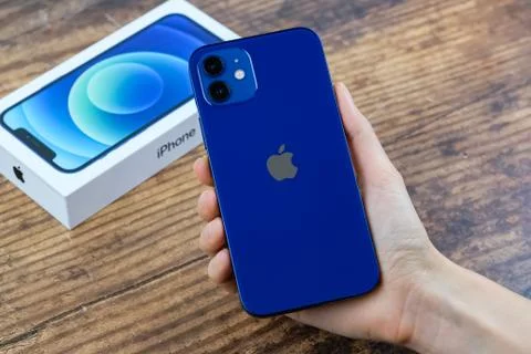 IPhone 12 in blue next to its box Stock Photos