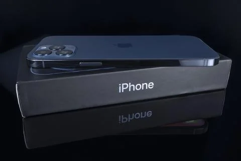 IPhone 12 Pro Max blue color over iPhone box Stock Photos