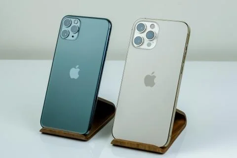IPhone 12 Pro Max Gold next to iPhone 11 Pro Max in Midnight Green color.  Stock Photos
