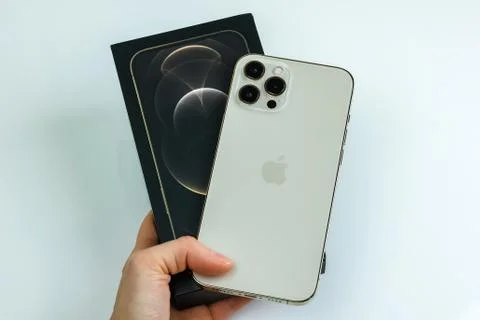 IPhone 12 Pro Max Gold next to its box Stock Photos