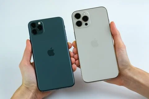 IPhone 12 Pro Max Gold next to iPhone 11 Pro Max in Midnight Green color.  Stock Photos