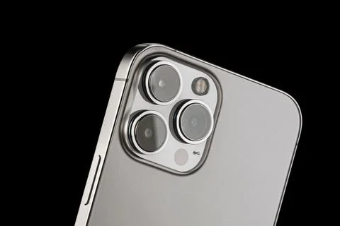 IPhone 13 pro on a black background. three close-up phone cameras, apple logo Stock Photos