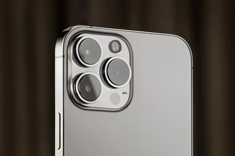 IPhone 13 pro on a black background. three close-up phone cameras, apple logo Stock Photos