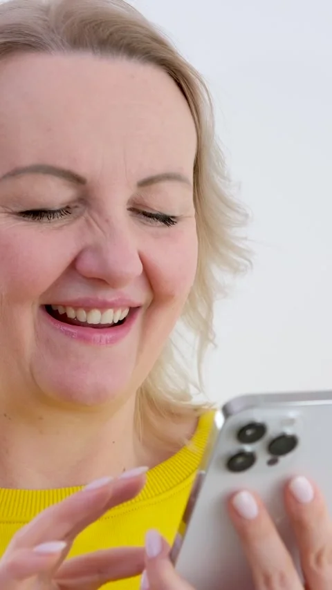 Iphone 13 pro max Cheerful caucasian woman is listening to music and dancing Stock Footage 244490670