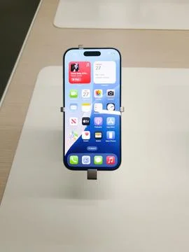 IPhone 16 smartphone Display in Modern Retail Store Setting. Stock Photos