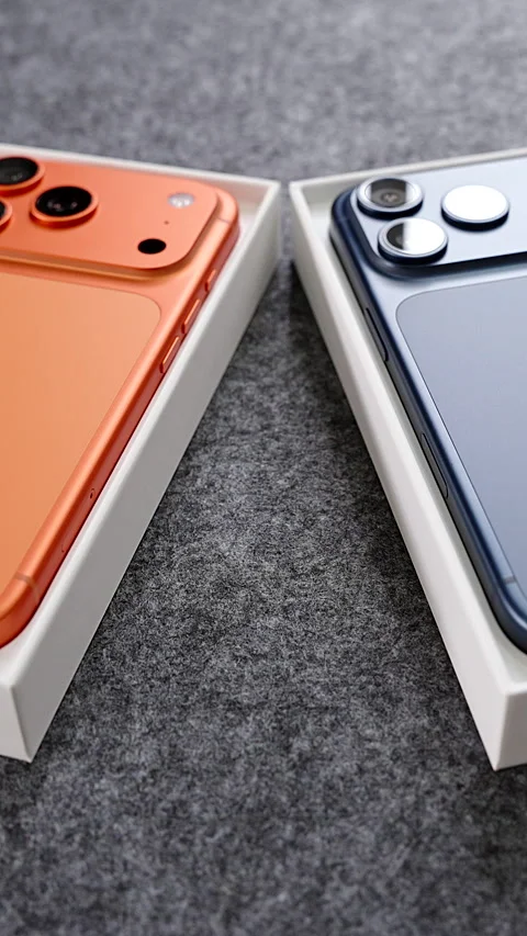 IPhone 17 Pro in Cosmic Orange and Deep Blue Colors Lying Inside Open Boxes on Video stock 318050974