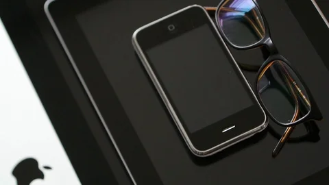 IPhone 3gs, iPad tablet iMac computer and eyeglasses Stock Footage 107783778