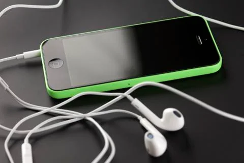 Iphone 5c with earpods Stock Photos