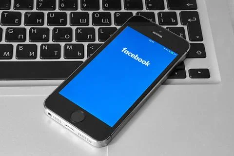 IPhone 5s with mobile application for Facebook Stock Photos