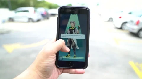 Iphone 6S Plus user playing Pokemon Go for the first time. Stock Footage 65773207