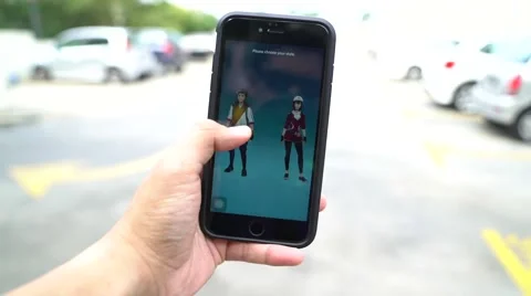 Iphone 6S Plus user playing Pokemon Go for the first time. Stock Footage 65773210