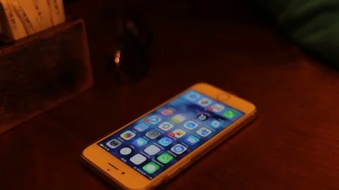 Iphone 7 lying on a wooden table in cafe Stock-Footage 75412154