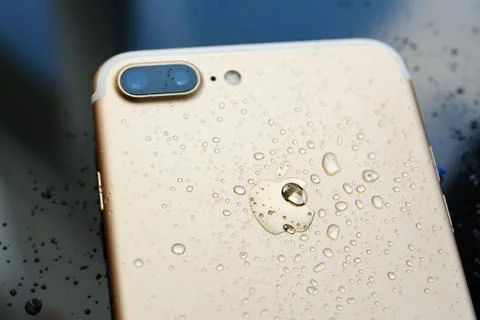 IPhone 7 Plus waterproof with rain drops on rear glass backgroud Stock Photos