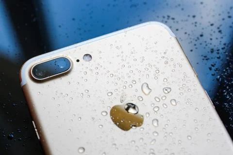 IPhone 7 Plus waterproof with rain drops on rear glass backgroud Stock Photos
