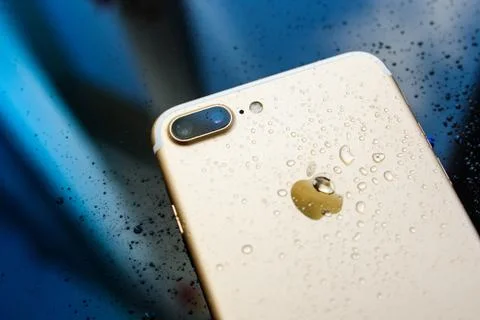 IPhone 7 Plus waterproof with rain drops on rear glass backgroud Stock Photos