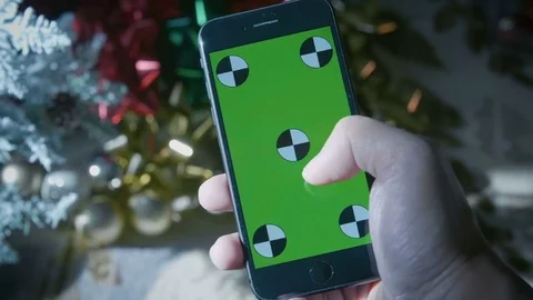 Iphone 8 being used with a green screen with tracking markers during a holiday Stock Footage 82850682